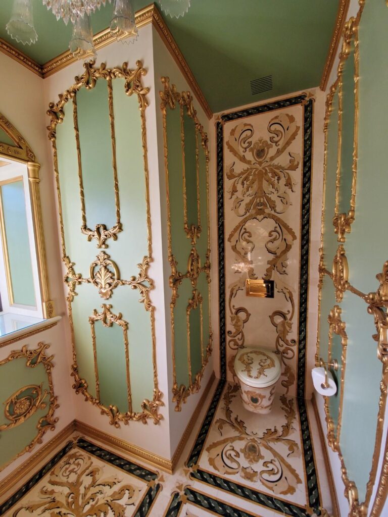 Designer mirror in powder room by Andrea D'Alessio