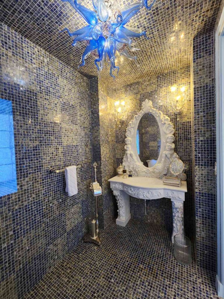 Elegant lighting in powder room by Andrea D'Alessio